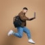 Profile photo of sporty active asian guy jumping with laptop computer