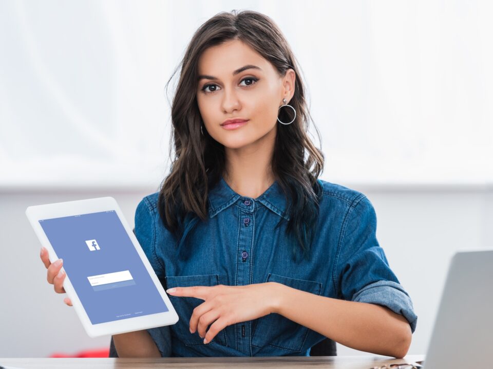 attractive-young-woman-pointing-on-digital-tablet-screen-with-facebook-website attractive-young-woman-pointing-on-digital-tablet-screen-with-facebook-website