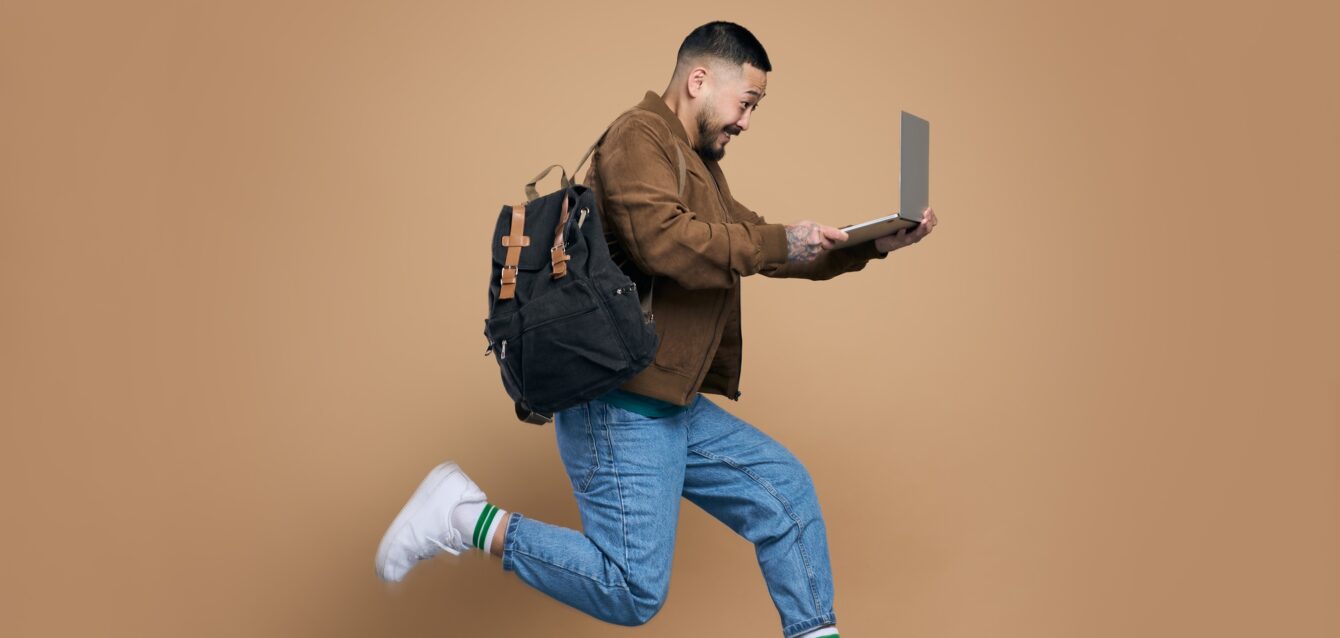 profile-photo-of-sporty-active-asian-guy-jumping-with-laptop-computer